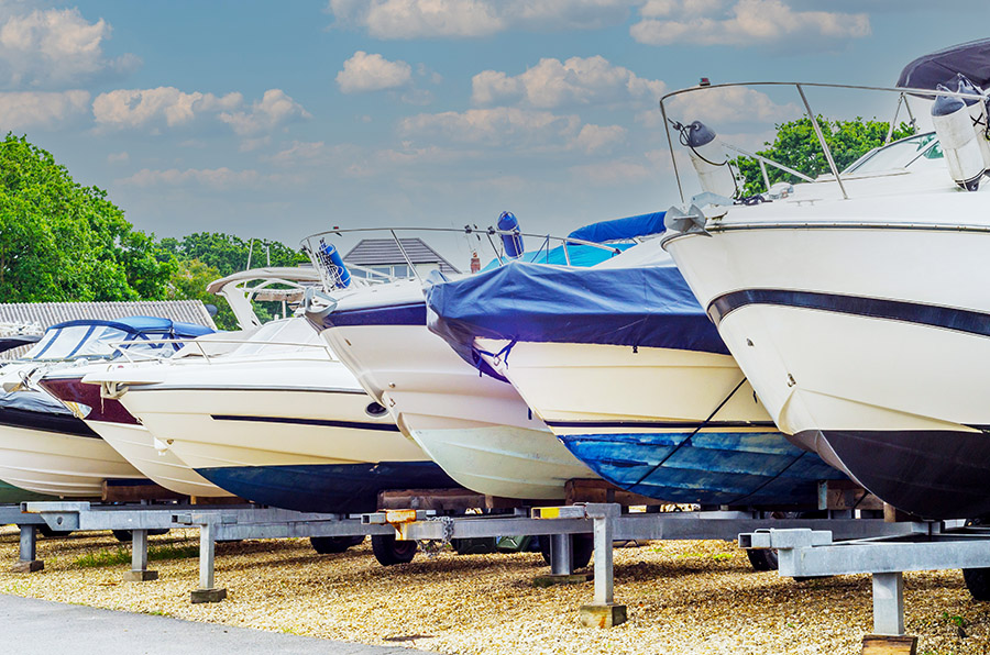 Several boats on their stands next to one another.